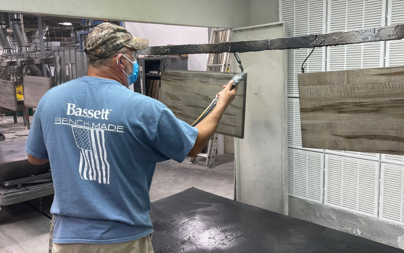 Workers take pride in what they produce at the BenchMade plant in Martinsville. An employee with a BenchMade shirt is seen finishing solid wood planks as they come down the line.