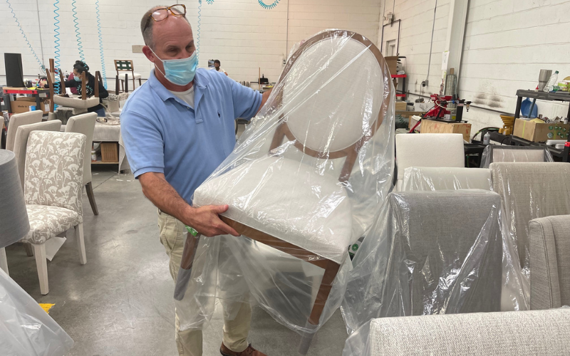 Carter Underwood, vice president, domestic wood manufacturing at Bassett Furniture, shows an upholstered dining chair that is about ready to ship.