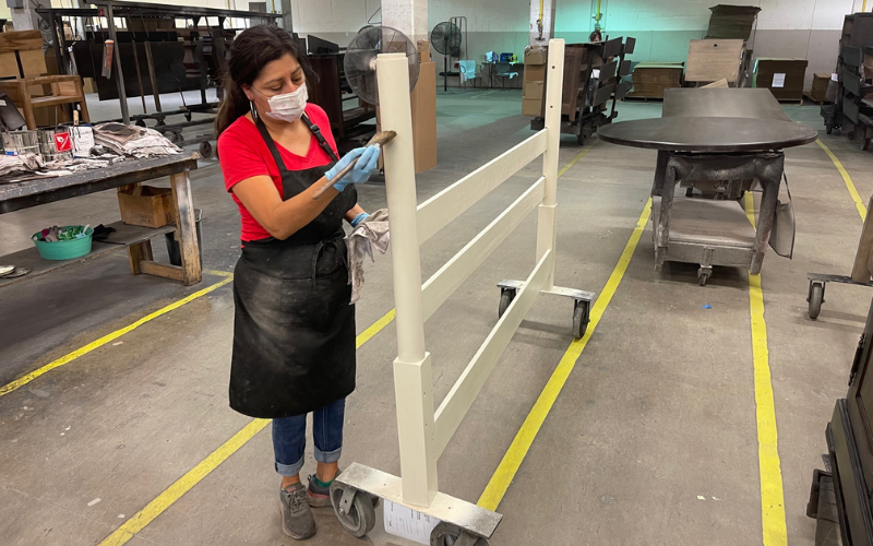 An employee in Bassett, Va. hand finishes part of a bed frame at the plant.