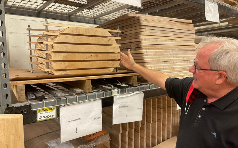 Bassett Furniture Inds. Senior Vice President and Chief Operations Officer John E. "Jeb" Bassett III shows a cross section of solid live edge maple.